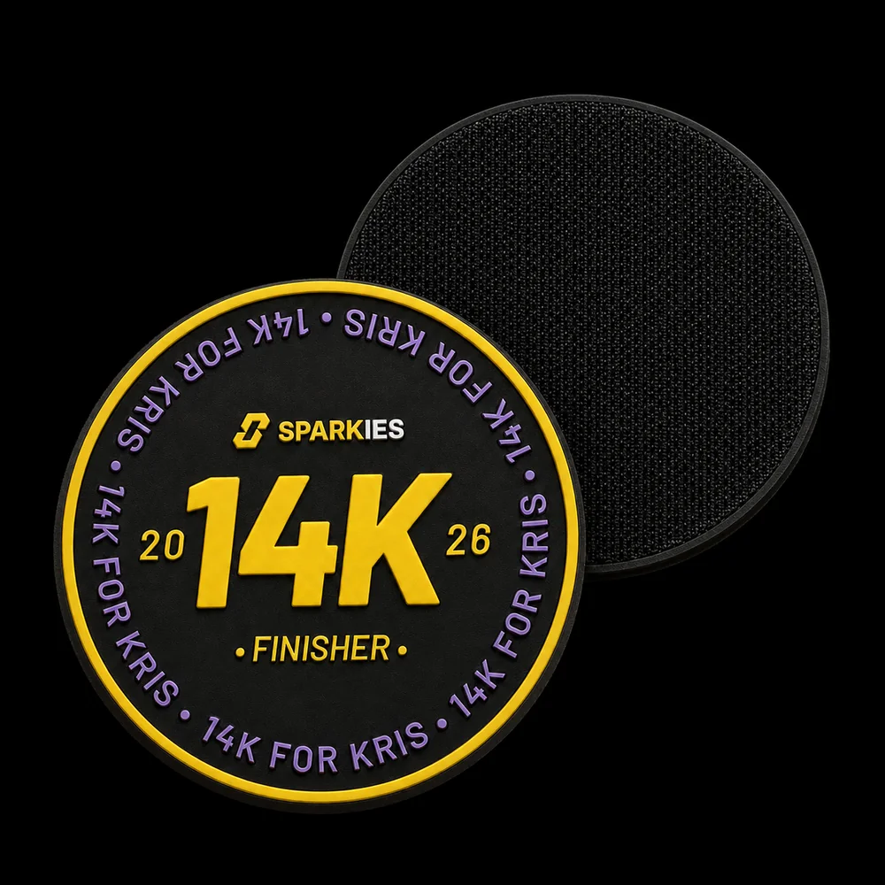 The 14k for Kris finisher patch: a black 3D PVC disc with a yellow ring, SPARKIES and a large 14K, FINISHER underneath, and 14K FOR KRIS around the rim in violet.